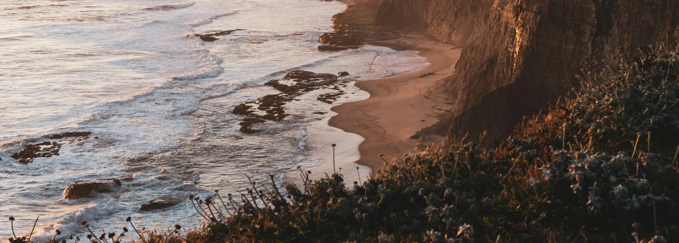A coastal cliff at golden hour.